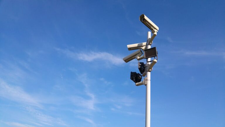 Security cameras in front of the clear blue sky